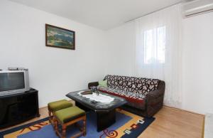 a living room with a couch and a tv at Apartments with parking space Murter - 5084 in Murter