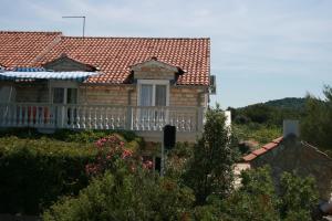 a house with a balcony and a roof at Apartments and rooms with parking space Jezera, Murter - 5082 in Jezera