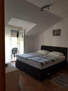 a bedroom with a large bed in a room at Apartments and rooms with parking space Jezera, Murter - 5082 in Jezera