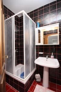 a bathroom with a sink and a shower at Apartments and rooms with parking space Jezera, Murter - 5082 in Jezera