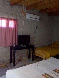 a bedroom with a desk with a laptop computer on it at Hotel de Campo Oeste Paraíso in La Ciénaga