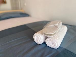 a pair of towels sitting on a bed at Rosa's House in Vazzano