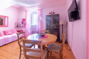 a living room with a table and chairs and a couch at Apartments by the sea Supetar, Brac - 6075 in Supetar