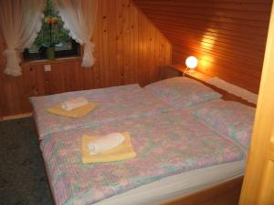 a bedroom with a bed with two towels on it at Počitniška hiša Ukanc in Bohinj