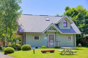 a house with a picnic table in front of it at First Villa in Yamanakako +39 photos