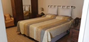 a bedroom with a large bed in a room at Departamentos La Marthita in Villa Mercedes