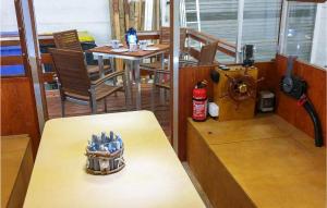 a room with a table and a room with a tableablish at Cozy Ship In Neuruppin With House Sea View in Neuruppin