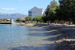 a group of people on a beach near the water at Apartments with a parking space Mirca, Brac - 728 in Mirce