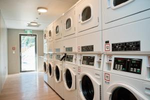 a row of washing machines in a laundry room at Driftaway Queenstown in Queenstown