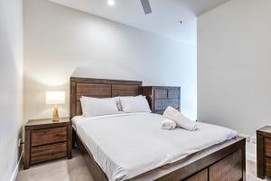 a bedroom with a large bed with a wooden headboard at Chic Inner City Position 2 bedroom apartment with Parking By Serain Residences in Brisbane