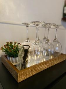 a tray with four wine glasses on a table at Chalé House Falkenberg in Monte Verde