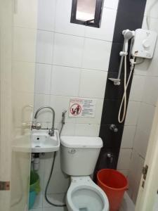 a small bathroom with a toilet and a sink at N&J Lopez Lodging House in Manila