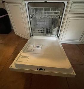 a dishwasher with its door open in a kitchen at The Piano House in Orlando