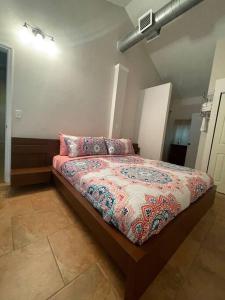 a bedroom with a bed with pillows on it at The Piano House in Orlando