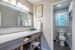 a bathroom with a sink and a mirror and a toilet at King Bd Nature Haven Dwntwn Alpharetta! Dogs Kids in Alpharetta +48 photos
