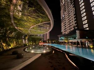 a swimming pool in a city at night at Dsistyle Islamic House in Kuala Lumpur