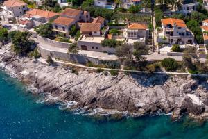 an aerial view of a house on a cliff next to the water at Double Room Puntinak 12255a in Selca