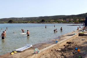 a group of people in the water at a beach at Secluded holiday house Pasman - 15649 in Pašman