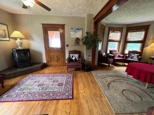 a living room with a rug on a hard wood floor at The Coastal Country House in New Brunswick in Cape Tormentine