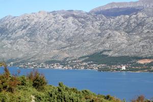 a view of a large body of water with mountains at Holiday house with a parking space Starigrad, Paklenica - 16126 in Starigrad