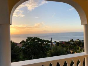 a view of the ocean from a balcony at Modern Air Conditioned Home For Family & Adventure in Loubiere