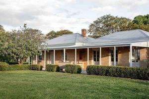 a house with a gambrel roof and a yard at Chatsworth Tasmania in Longford
