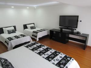 Ένα ή περισσότερα κρεβάτια σε δωμάτιο στο Hotel Palermo Suite