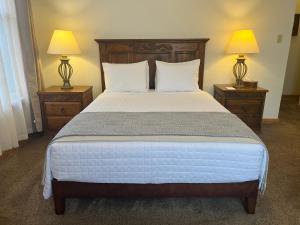 a bedroom with a large bed with two night stands at Canyon Rose Suites in Bisbee