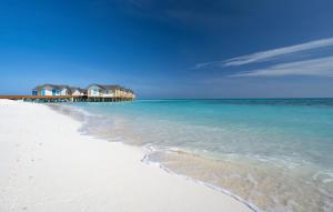 a white beach with houses in the ocean at Cora Cora Maldives - Premium All-Inclusive Resort in Raa Atoll