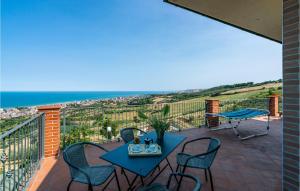 a patio with a table and chairs and the ocean at Nice Home In Belsito With Wifi in Montepagano