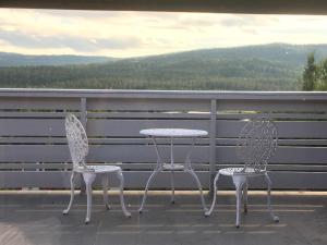 two chairs and a table on a balcony with a view at Bed and Breakfast Hadeland in Harestua