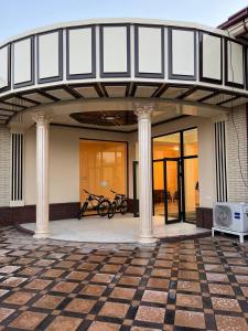 a building with two bikes parked on a patio at Samarabonu Hotel in Samarkand