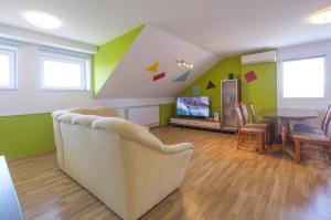 a living room with a couch and a table at ITSOFT smart apartment in Komenda