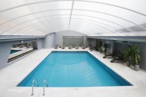 a swimming pool in a building with a ceiling at Altis Grand Hotel in Lisbon