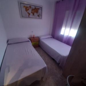 A bed or beds in a room at Apartamento cerca Playa Napoli II Még 23 kép