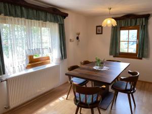 a dining room with a wooden table and chairs at Ferienhaus Bergblick in Kaning