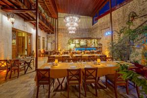 a restaurant with tables and chairs in a room at Le Reve Butik Otel in Hatay