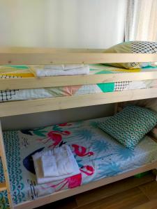 a bunk bed with towels and pillows on it at leflamantduport in Hyères +8 photos