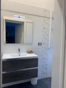 y baño con lavabo y espejo. en Residence Petrone, en Foggia