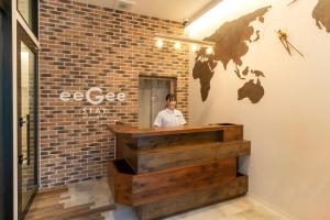 a man standing at a counter in a brick wall at eeGee STAY Kamata in Tokyo