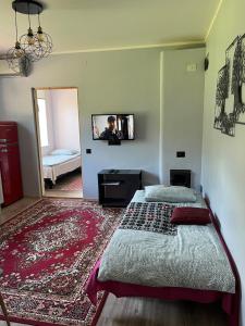 a bedroom with a bed and a tv on the wall at Maria Apartment Roomassaare in Kuressaare