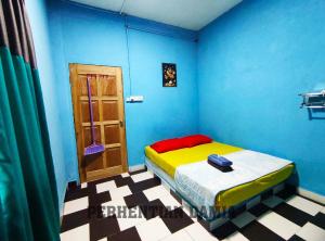 a blue room with a bed and a door at Perhentian Damia in Perhentian Island