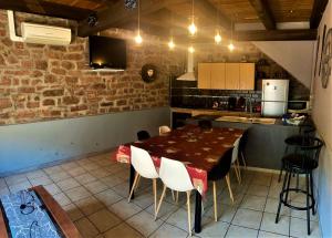 a kitchen and dining room with a table and chairs at Au nid de la foret in Boersch +15 photos