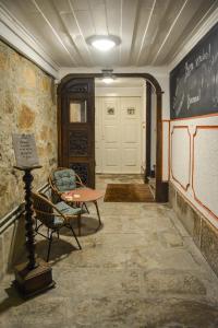 a hallway with a table and chairs in a room at inBraga Hostel in Braga