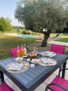 a blue picnic table with food and drinks on it at Le Truc Bidule in Murs