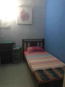 Ein Bett oder Betten in einem Zimmer der Unterkunft Borneo Sweet Guesthouse