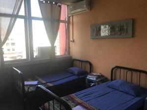 Ein Bett oder Betten in einem Zimmer der Unterkunft Borneo Sweet Guesthouse