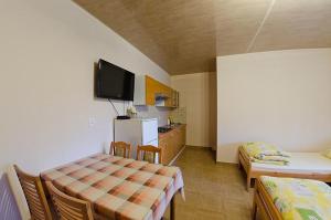 a room with two tables and a tv on the wall at Agroturystyka Nad Tanwią in Budziarze
