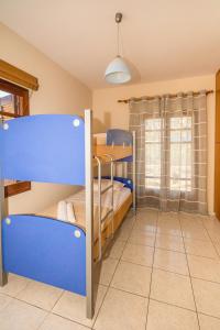 a room with two bunk beds and a window at Strevagio family house in Kissamos +9 photos