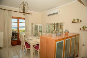 a dining room with a table and chairs and a window at Strevagio family house in Kissamos